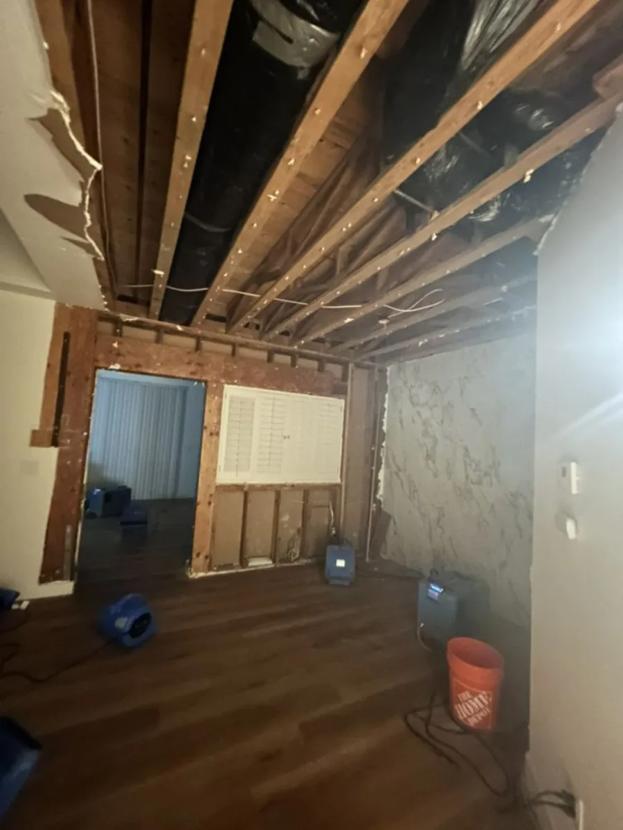 Air movers operating in a room with exposed structural materials